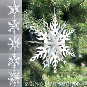 May include: White paper snowflake ornaments hanging on a Christmas tree. The ornaments have intricate cut-out designs. The image also shows several other snowflake designs. The bottom right corner of the image has the text "SVG PNG DXF EPS JPG PDF".