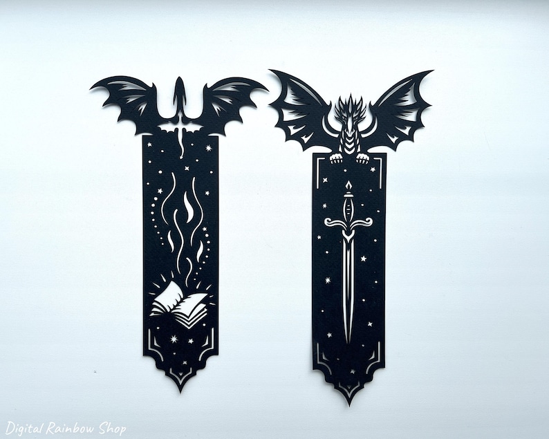 May include: Two black dragon-themed bookmarks. One features a dragon with a sword, the other a dragon with a book and flames. The bookmarks are cut from a dark material and have intricate designs. The text "Digital Rainbow Shop" is at the bottom.