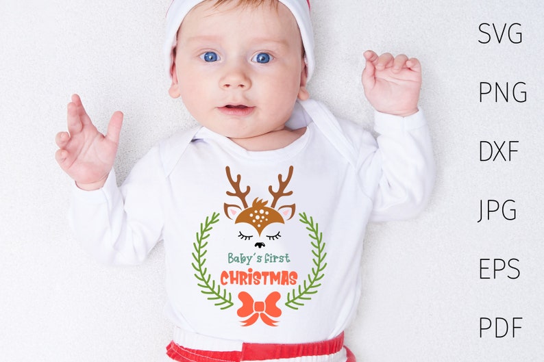 Puede incluir: Un pelele blanco con un lindo dise&ntilde;o de reno y el texto "Baby's First Christmas".