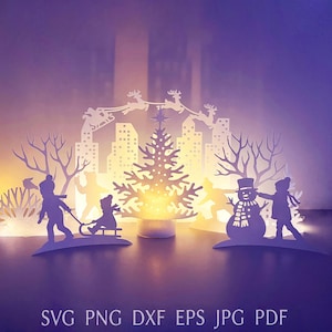 May include: A paper cut-out Christmas scene with a city skyline, Christmas tree, and children playing in the snow. The scene includes a snowman, a sled, and Santa's sleigh. The image has a purple and yellow gradient background. The text at the bottom reads: SVG PNG DXF EPS JPG PDF.
