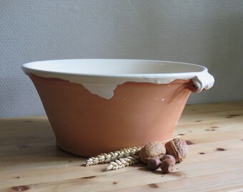 Handmade ceramic salad/fruit bowl or to prove bread in,the bowl is glazed with slib in creme and a clear glaze.the outside is unglazed.