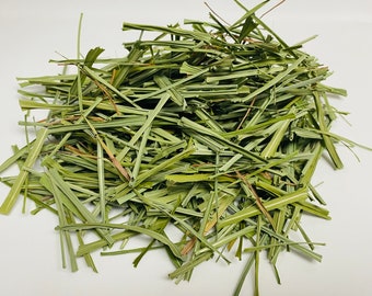 May include: A pile of dried, light green lemongrass, chopped into thin strips.