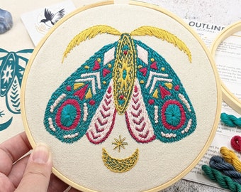 Hoop embroidery kit. Moth folk art inspired teal screen printed design on natural cotton canvas. 6”