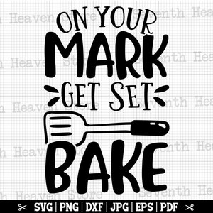 May include: Black and white graphic design with the text "On Your Mark Get Set Bake" and a spatula.