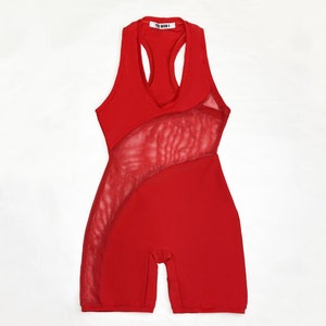 May include: Red one-piece swimsuit with a mesh panel on the side. The swimsuit has a racerback style and a V-neck.