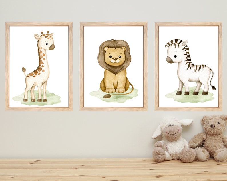 May include: Three framed watercolor illustrations of safari animals. The first frame shows a giraffe with brown spots, the second frame shows a lion with a brown mane, and the third frame shows a zebra with black and white stripes.