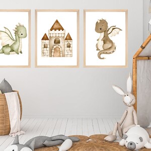 May include: Three watercolor illustrations in wooden frames, featuring a green dragon, a brown dragon, and a brown castle. The illustrations are on a white background.