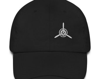 May include: A black baseball cap with a white embroidered propeller design.