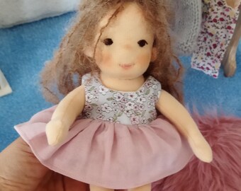 8'' inch handmade Waldorf doll. Comes with 2 different outfits,knitted cardigan set and a carrying bag. Ecofriendly natural cloth doll.