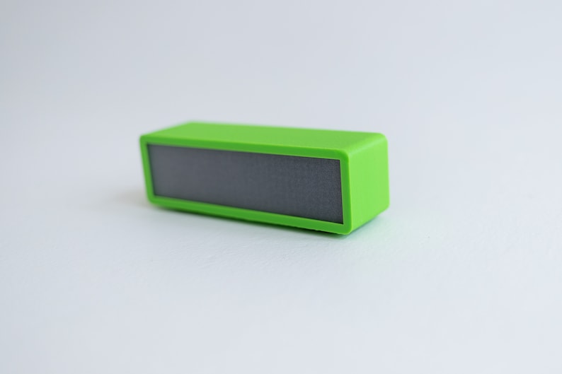 May include: A small, bright green portable speaker with a black speaker grille.