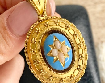 May include: A gold oval locket with a blue enamel centre and a star design with pink pearl accents.