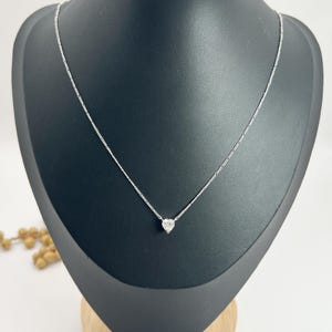0.70 Carat Diamond Heart Pendant Necklace Suspended from a Platinum Figaro Link Chain