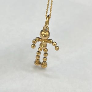 Ciondolo/pendente vintage in oro 9 carati, raffigurante una figura umana articolata, circa 1980
