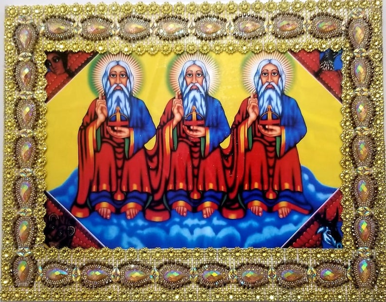 May include: A framed religious icon depicting three figures with long white beards and red robes. The figures are holding crosses and are surrounded by a gold frame with ornate details.