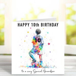 May include: A birthday card with a watercolor illustration of a soccer player in a colorful uniform. The card reads "HAPPY 10th BIRTHDAY" and "to a very Special Grandson". The player's jersey has the name "ALFIE" and the number "10".