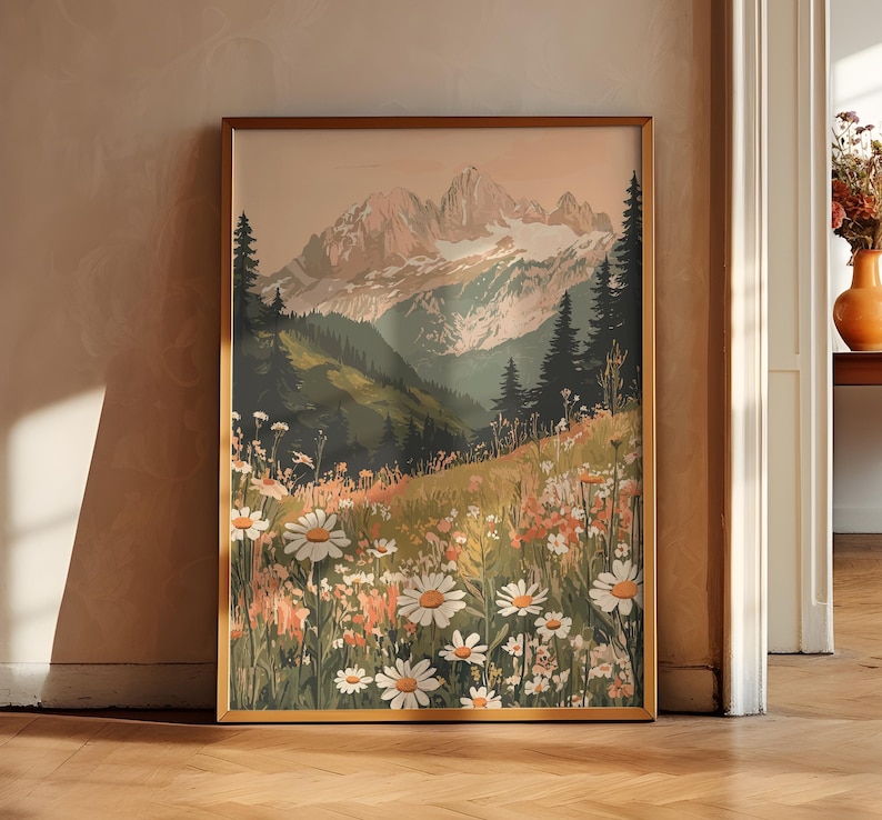 May include: A framed print of a mountain landscape with a field of white daisies in the foreground. The mountains are in the background and are a light brown color. The sky is a light blue color.