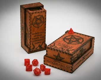 May include: Two wooden dice towers with a pentagram design and the text "Do not call up that which you cannot put down". The towers are made of dark wood and have a red dice on top. There are also several red dice scattered on a white surface.