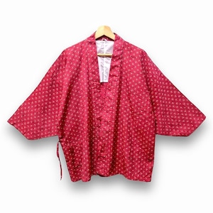 May include: A red kimono with a white floral pattern. The kimono has a V-neck and is tied at the waist with a sash.