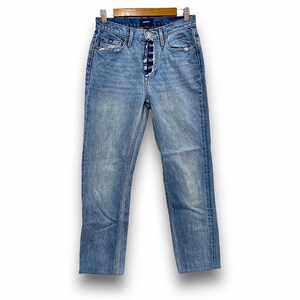 May include: Light blue denim jeans with a button fly, five pockets, and a straight leg. The jeans are hanging on a wooden hanger against a white background. The jeans have a faded wash and are slightly distressed.