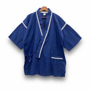 May include: A navy blue kimono-style robe with white lace trim along the lapels, sleeves, and pocket. The robe has a tie closure at the waist and is hanging on a wooden hanger. The fabric appears to be a lightweight cotton or linen.