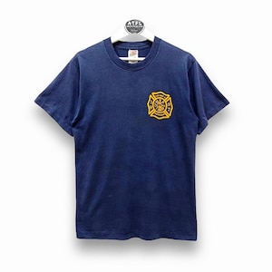 May include: A navy blue t-shirt with a yellow embroidered firefighter emblem. The emblem features a crossed axe and hose, a fire hydrant, and the text "Fire Dept. 1997"