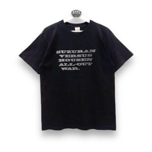 May include: Black t-shirt with the text "SUZURAN VERSUS HOUSEN ALL-OUT WAR." printed in white.