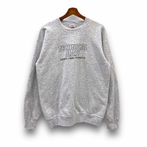 May include: A gray sweatshirt with the text "TECHNICAL MATE SPORTS CARS PRODUCTS" printed on the front.