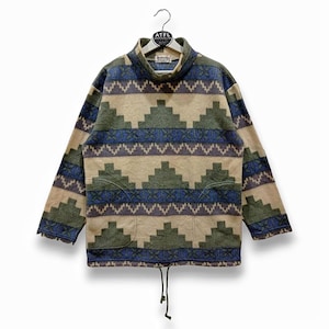 May include: A beige, green, and blue patterned fleece pullover with a mock neck and a drawstring at the bottom.