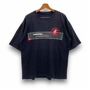 May include: Black Rocawear t-shirt with a crew neck. The shirt features a rectangular patch with the brand name and logo in red and white. The text "ENTER NAME OF HIP HOP" is also visible.