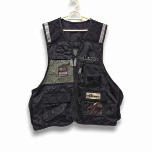 May include: A black utility vest with multiple pockets and mesh panels. The vest has reflective accents and the word "ellesse" printed on the front in white.