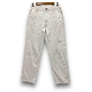 May include: Off-white denim jeans hanging on a wooden clothes hanger. The jeans feature a classic five-pocket design, button and zip fastening, and a straight leg. The fabric appears to be medium-weight denim, suitable for various occasions.