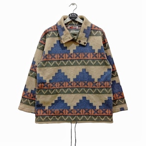 May include: A brown, blue, green, and orange patterned fleece jacket with a high collar and a drawstring at the bottom.