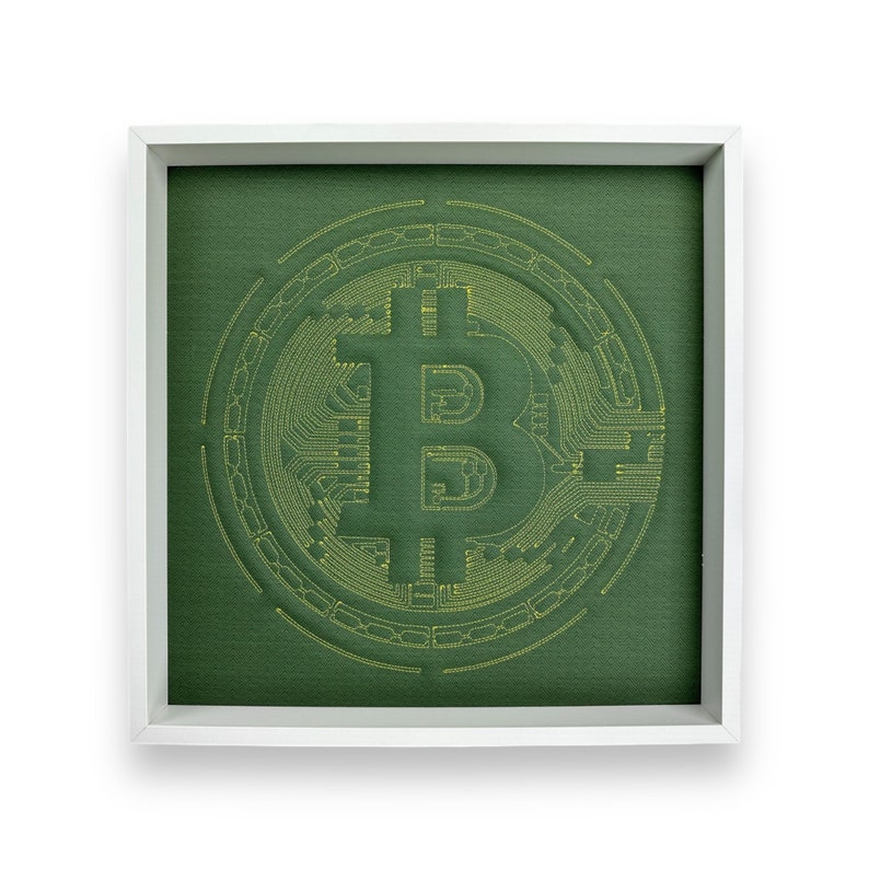 May include: A framed green canvas with a yellow embroidered Bitcoin symbol.