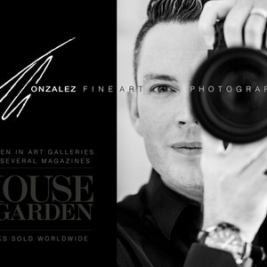 May include: Black and white photo of a photographer holding a camera up to their face. The text "ONZALEZ FINE ART PHOTOGRAPHY" is visible in the image. The text "AS SEEN IN ART GALLERIES AND SEVERAL MAGAZINES" is also visible. The text "HOUSE & GARDEN" is visible in large bold letters. The text "WORKS SOLD WORLDWIDE" is visible at the bottom of the image.