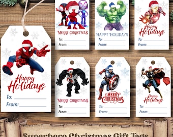 May include: Superhero-themed Christmas gift tags featuring various characters like Spider-Man, Hulk, and Captain America, all wearing Santa hats. Each tag has space to write "To:" and "From:" and is decorated with snowflakes. The tags are on a wooden surface.