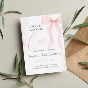 Puede incluir: Invitaci&oacute;n de primer cumplea&ntilde;os rosa y blanca con un lazo de acuarela y el texto "Girls Just Wanna Be One" y "Amelia's First Birthday". La invitaci&oacute;n incluye la fecha, la hora y la direcci&oacute;n de la fiesta.
