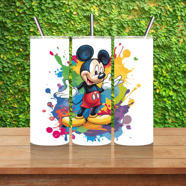 May include: Three white tumblers with a colourful paint splatter design and a cartoon image of Mickey Mouse.