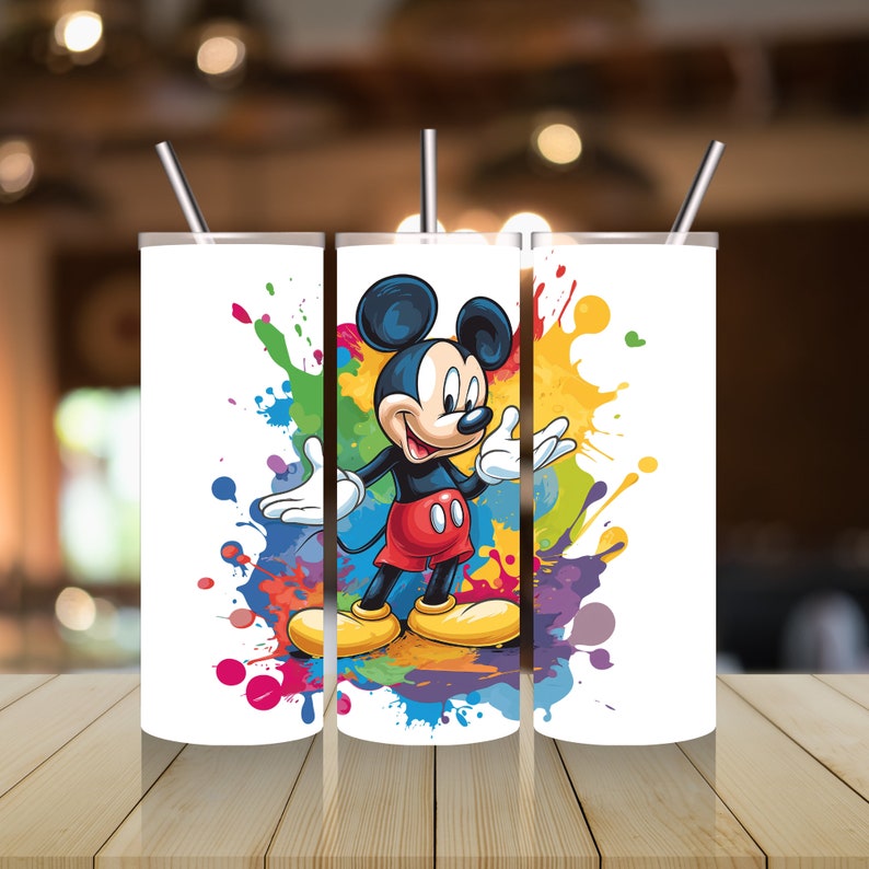 May include: Three white stainless steel tumblers featuring a colourful paint splatter design and a cartoon image of Mickey Mouse in the centre.