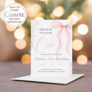 Pode incluir: Um convite de primeiro aniversário rosa e branco com um laço de aquarela e o texto "Girls Just Wanna Be One". O convite inclui o nome "Amelia's First Birthday", a data "July 25", a hora "2PM" e o endereço "123 anywhere st., any city, st 12345". As informações RSVP são "Please RSVP to Gabrielle at 123-456-7890".