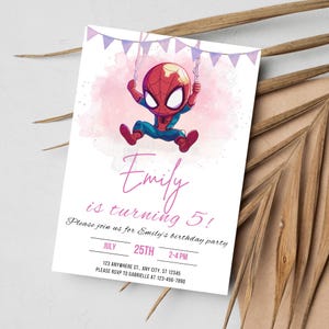 May include: A pink and purple birthday party invitation with a cartoon image of Spiderman swinging from a string of purple and white flags. The text on the invitation reads "Emily is turning 5! Please join us for Emily's birthday party. July 25th 2-4 PM 123 Anywhere St., Any City, ST 12345 Please RSVP to Gabrielle at 123-456-7890"