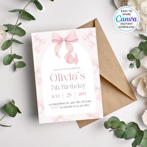 May include: A birthday invitation with a pink bow design. The invitation includes the text "Olivia's 7th Birthday" with the date and time. The invitation is accompanied by a brown envelope and decorative greenery.