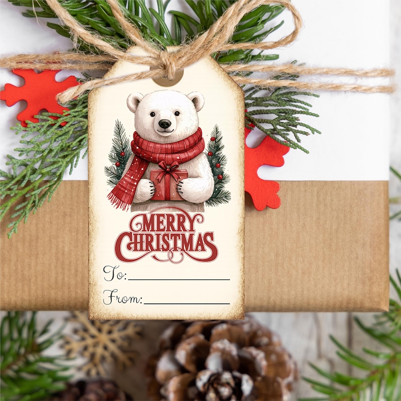 May include: A gift tag with a polar bear illustration wearing a red scarf and holding a present. The tag has the words "MERRY CHRISTMAS" in red script, with lines for "To:" and "From:" on a gift wrapped in brown paper and white paper.