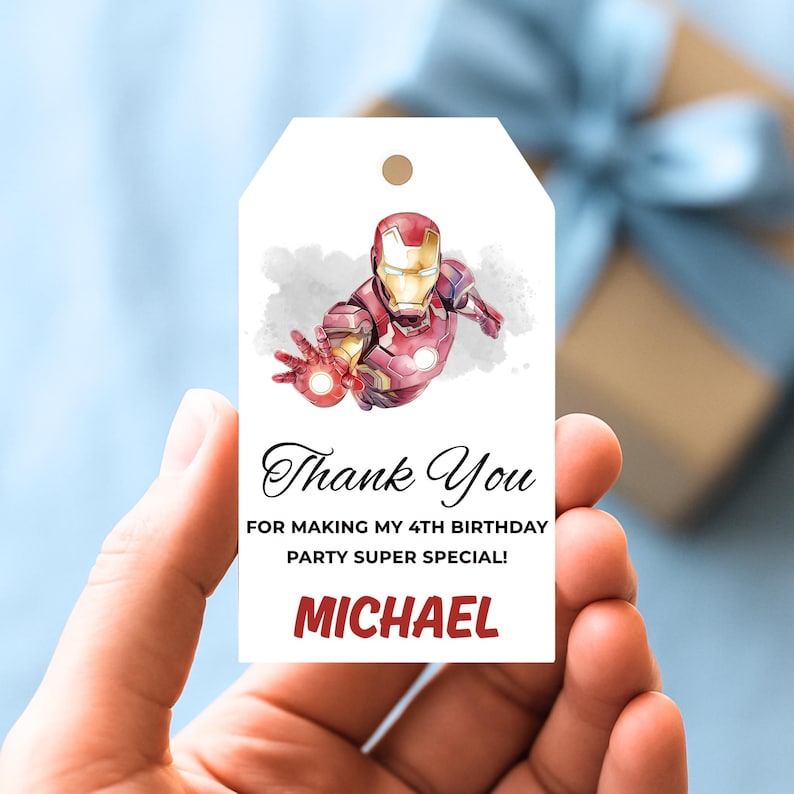 May include: White gift tag featuring an Iron Man illustration. The tag includes the text "Thank You" and "For making my 4th birthday party super special!" with the name "MICHAEL" in red.