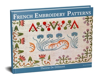 Op de afbeelding: Een boek getiteld "French Embroidery Patterns" van Therese De Dillmont. De omslag toont een kleurrijk geborduurd ontwerp met bloemen, bladeren en geometrische vormen.