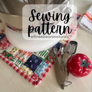 May include: A white ceramic mug with a black handle and the text "But first, coffee" in a handwritten style. The mug is on a white surface. The mug is 4 inches tall.