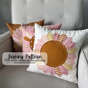 May include: Three decorative pillows with a sunflower design. The pillows have a white background with a quilted pattern. The sunflower petals are pink, yellow, and brown. The center of the sunflower is a solid brown color. The text on the image says "Sewing Pattern".