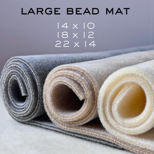 May include: Three rolled up bead mats in gray, tan, and ivory. The mats are available in three sizes: 14 x 10 inches, 18 x 12 inches, and 22 x 14 inches.