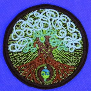 Puede incluir: Parche bordado con un árbol estilizado con ramas verdes y marrones, hojas azules y blancas y un globo terráqueo marrón y azul en la base.
