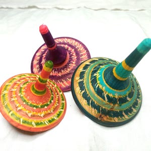 Colorful wooden spinning top, engraved and hand painted, long rotation.
