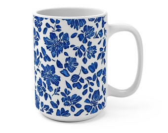 May include: White ceramic mug with a blue and white floral pattern. The mug has a large handle and is a standard size.